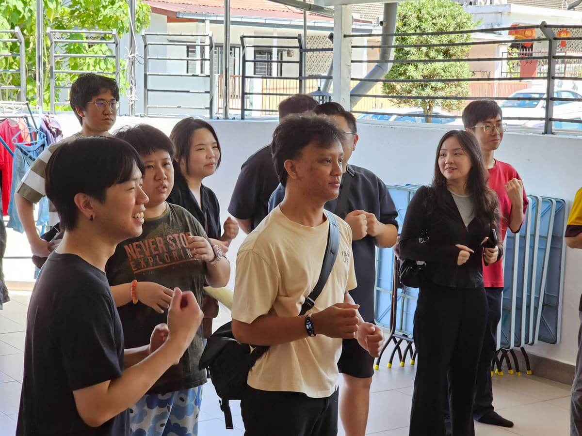 AGM Group colleagues clapping and singing along during the CSR charity visit at PKKII Insan Home in Happy Garden, Kuala Lumpur